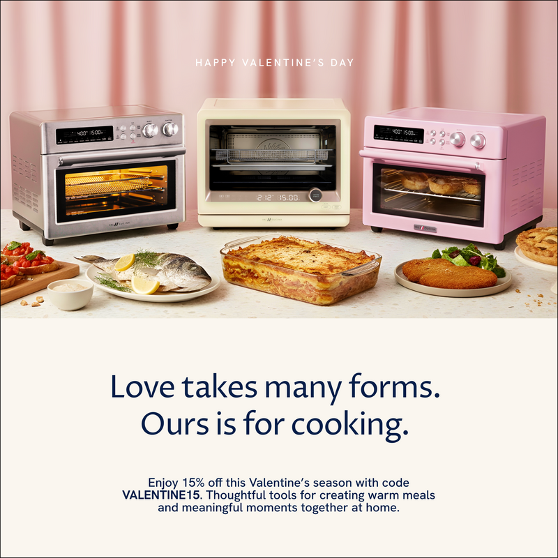 Three ovens on a table with food and a promotional message for Valentine's Day.
