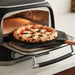 Neapolitan Margherita pizza on a peel coming out of the Val Cucina Pizza Oven