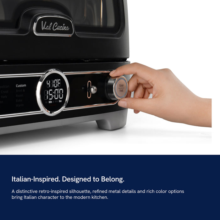 Hand setting the dial on the Val Cucina Pizza Oven: Italian-inspired design, designed to belong