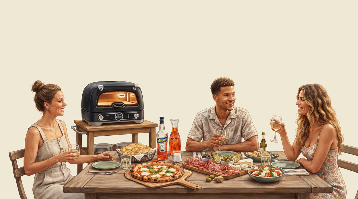 Friends dining around a table with the Val Cucina Pizza Oven on a serving cart